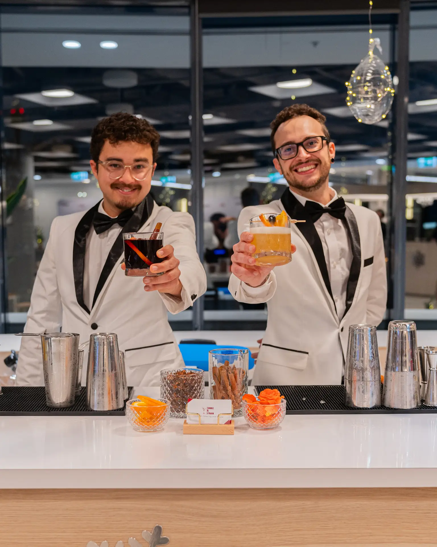 Bartenders with cocktails